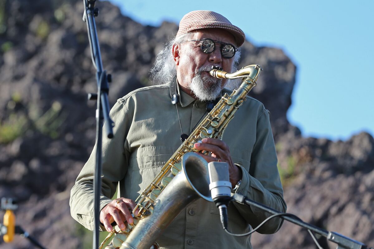 Man plays saxophone.
