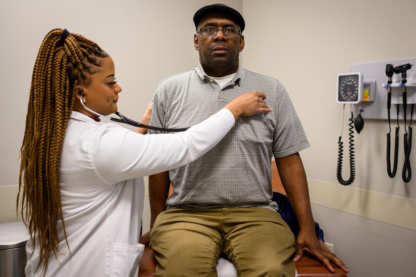 West Memphis, Ark. - Dr. Adrienne Hatchett, left, goes through a routine check up with Samuel Camon, of West Memphis, Ark., at the East Arkansas Family Health Center in West Memphis, Ark. on Friday March 6, 2019. CREDIT: William DeShazer