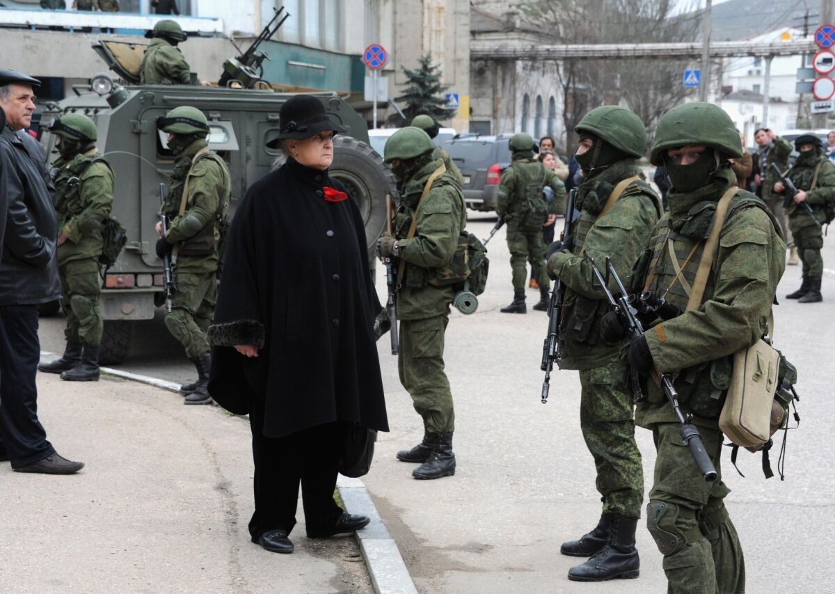 Troops block a base of the Ukrainian frontier guard unit in the Crimean town of Balaklava, Ukraine. Russian forces have been sent to the Crimean region, which is strongly opposed to the transitional pro-Western government in the Ukrainian capital, Kiev.