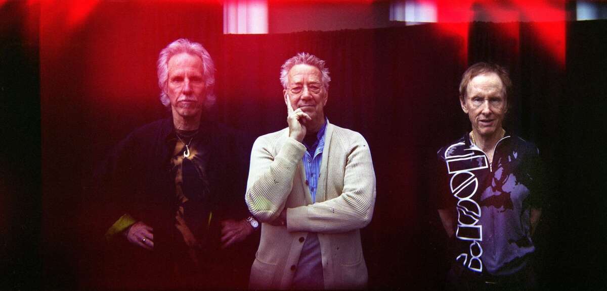 John Densmore, left, Ray Manzarek and Robby Krieger of the Doors appear in a triple exposure composite photo from 2010.