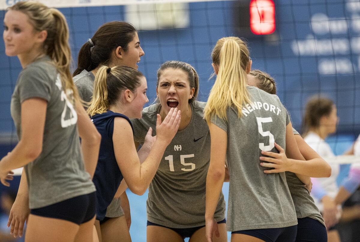 Newport Harbor celebrates a point during the Battle of the Bay girls' volleyball match against Corona del Mar on Wednesday.
