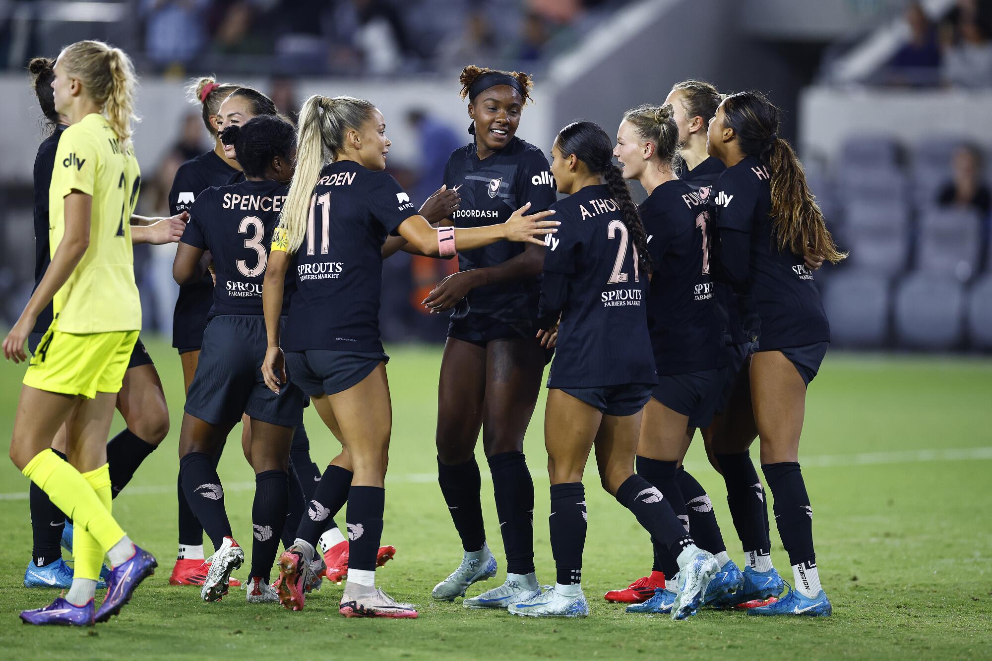 Angel City's Messiah Bright celebrates with teammates after scoring a goal against the Washington Spirit