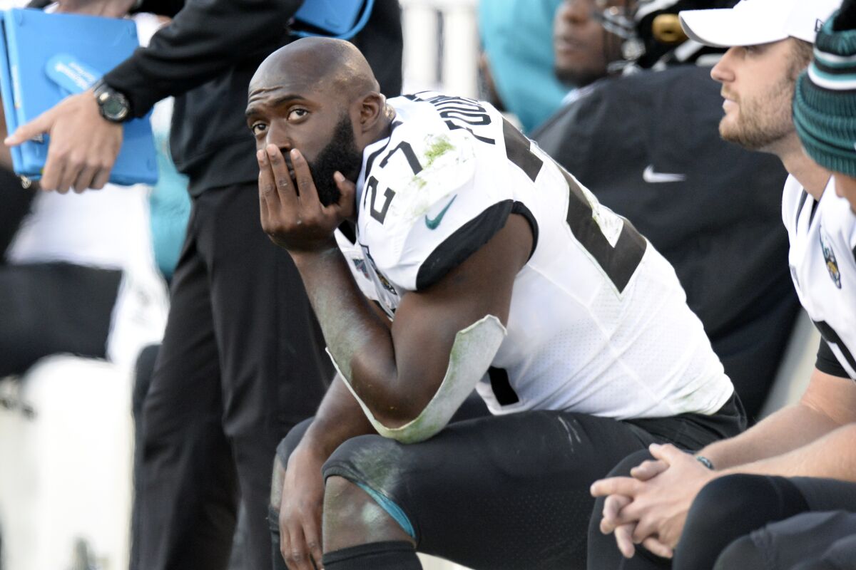 FILE - In this Nov. 24, 2019, file photo, Jacksonville Jaguars running back Leonard Fournette (27) sits on the bench in the first half of an NFL football game against the Tennessee Titans, in Nashville, Tenn. The Jacksonville Jaguars have waived running back Leonard Fournette, a stunning decision that gets the team closer to purging Tom Coughlin's tenure. (AP Photo/Mark Zaleski, File)