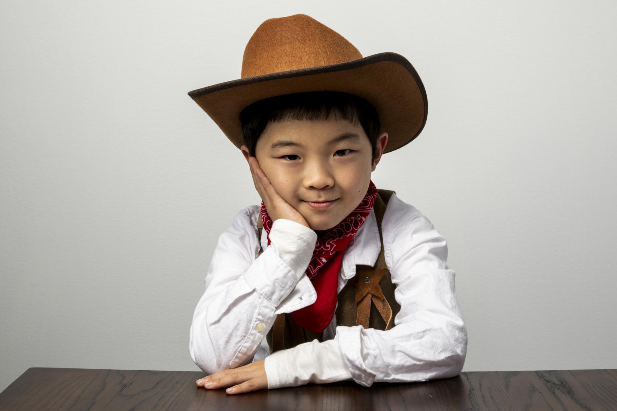 Alan Kim wears a cowboy outfit to a “Minari” photo shoot at the 2020 Sundance Film Festival.