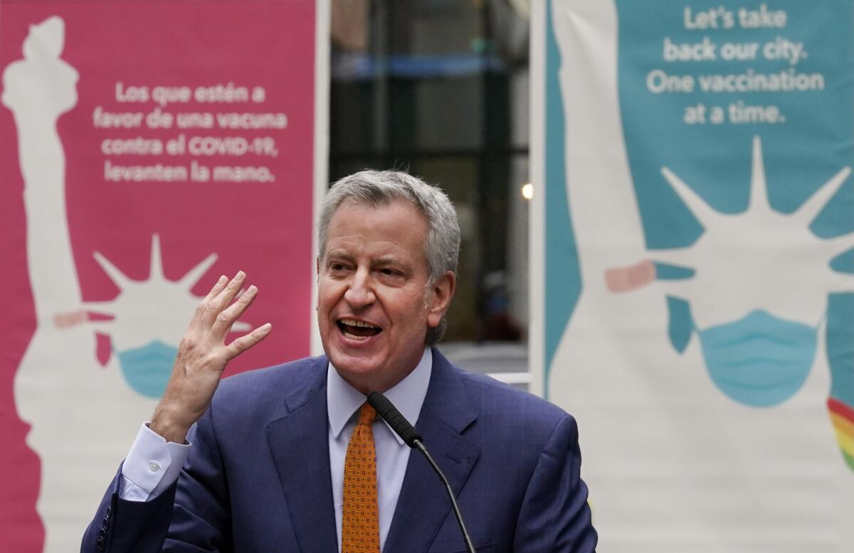  Bill de Blasio speaks into a microphone