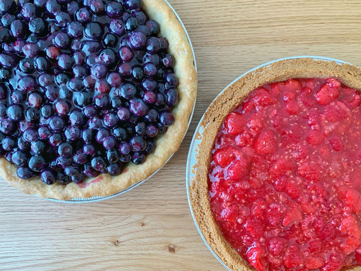 A duo of fresh blueberry and raspberry pies 