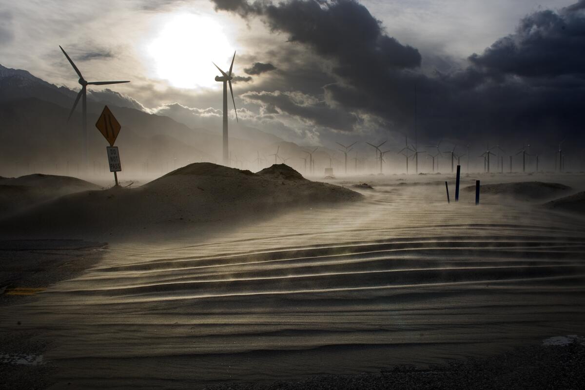 Gusting high winds blow large sand dunes from the wind farm onto Indian Canyon Drive