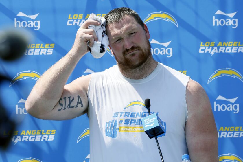 Los Angeles Chargers offensive tackle Bryan Bulaga dries off during a news conference after an NFL football team practice in Costa Mesa, Calif., Thursday, Aug. 12, 2021. (AP Photo/Alex Gallardo)