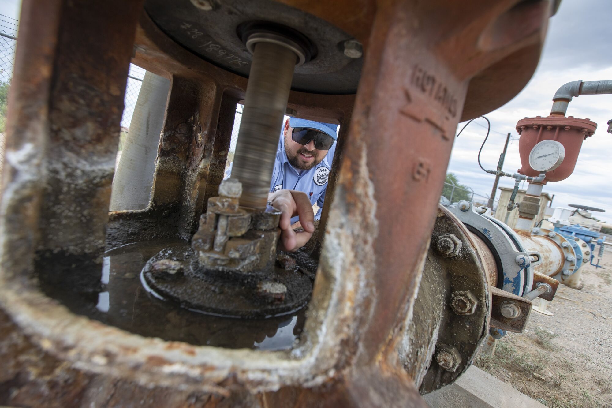 City of Needles Water operator Taylor Miller inspects the pump packing at well 15, the only operating water supply