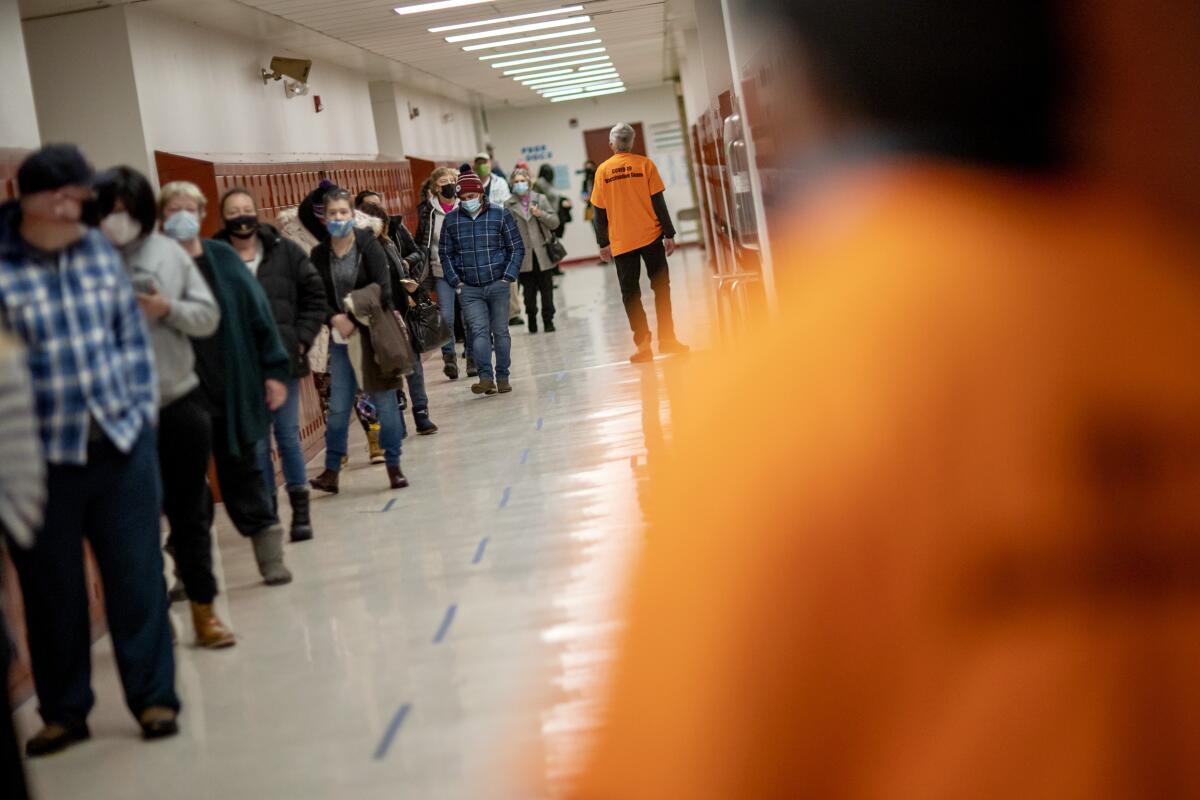 People line up for vaccines at a clinic in Central Falls, R.I.