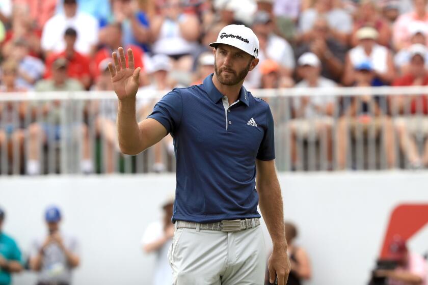 Dustin Johnson reacts on the 18th green after a putt during the final round of the Bridgestone Invitational in Akron, Ohio on July 3.