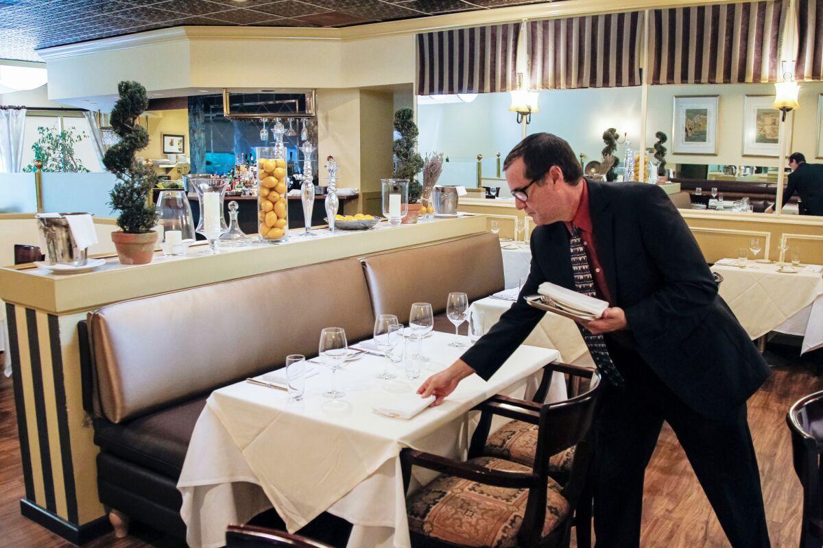Sommelier Greg Frech gets the details right before dinner service at The WineSellar & Brasserie in Sorrento Mesa.