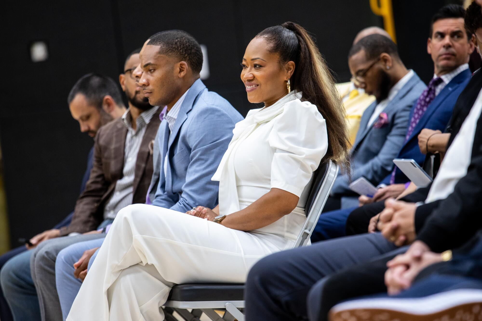 Deneitra Ham, with son Donovan to her right, watches the news conference announcing her husband as coach of the Lakers.