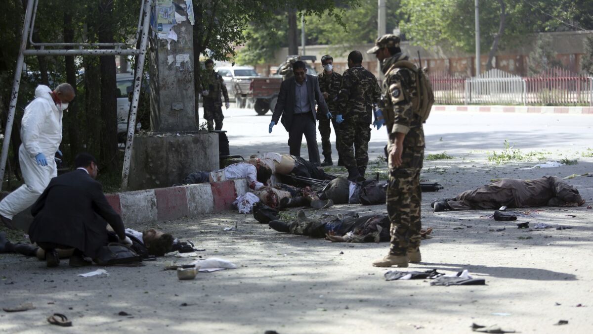 A coordinated double suicide bombing hit central Kabul, leaving victims sprawled on the ground in the Afghan capital on April 30, 2018.