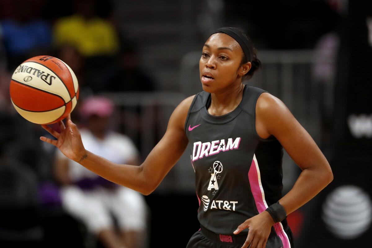 Atlanta Dream guard Renee Montgomery, part of the team's ownership group, passes the ball during a game.