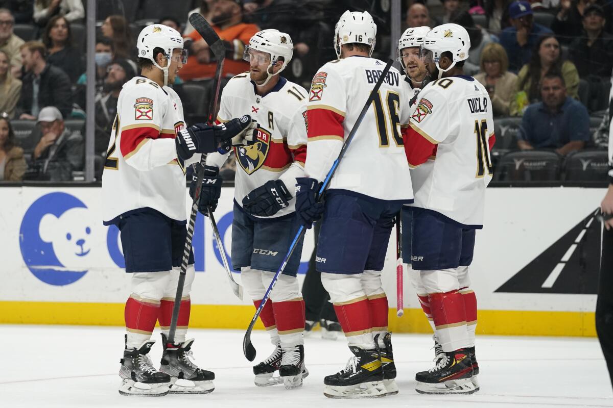 Panthers left wing Jonathan Huberdeau (11) celebrates with teammates after scoring during the first period March 18, 2022. 