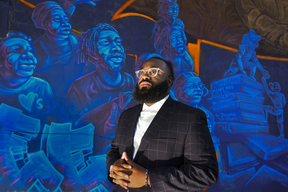 Pastor Aaron Marble stands in front of a mural in the historically black community of North Nashville, Friday, Feb.11, 2022, in Nashville, Tenn. The area is being combined into a mostly white congressional district, a move Marble believes will unfairly affect black voters. (AP Photo/John Amis)