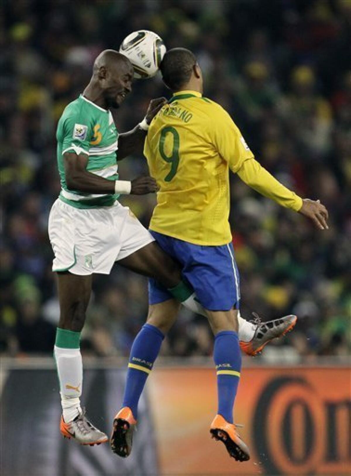 Brazil's Luis Fabiano, right, and Ivory Coast's Didier Zokora, left, compete for the ball during the World Cup group G soccer match between Brazil and Ivory Coast at Soccer City in Johannesburg, South Africa, Sunday, June 20, 2010. (AP Photo/Matt Dunham)