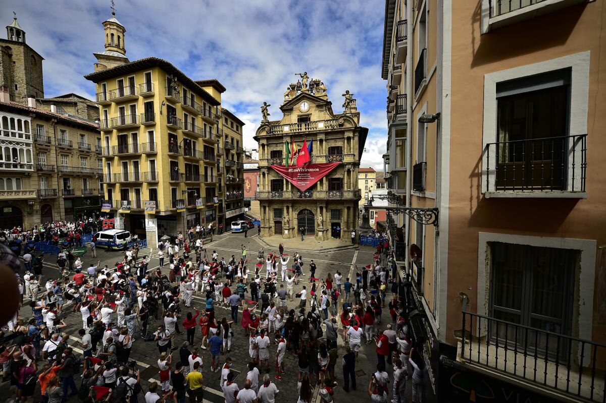 Residents in white clothes and traditional red scarves take to the streets of Pamplona, Spain -- with nary a bull in sight.