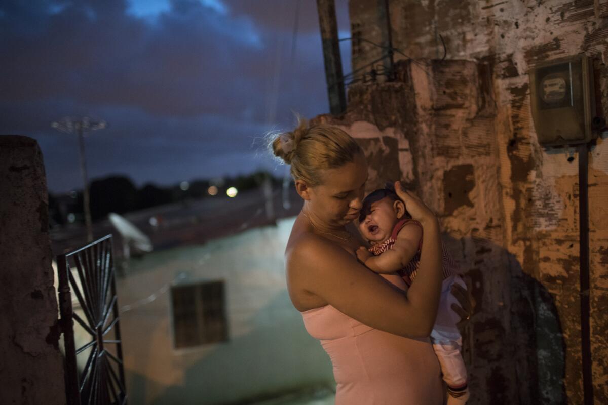 Gleyse Kelly da Silva holds her daughter, Maria Giovanna, who was born with microcephaly, outside their house in Recife, Brazil. Brazilian officials believe there's a sharp increase in cases of microcephaly and strongly suspect the Zika virus.