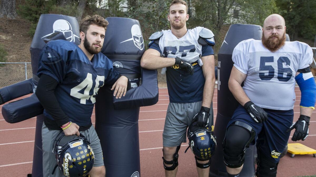 Patryk Guk, left, Kilian Zierer, center, and Philip Weinzierl are on the playoff bound with the College of the Canyons football team posing on the field during practice in Valencia on Thursday.