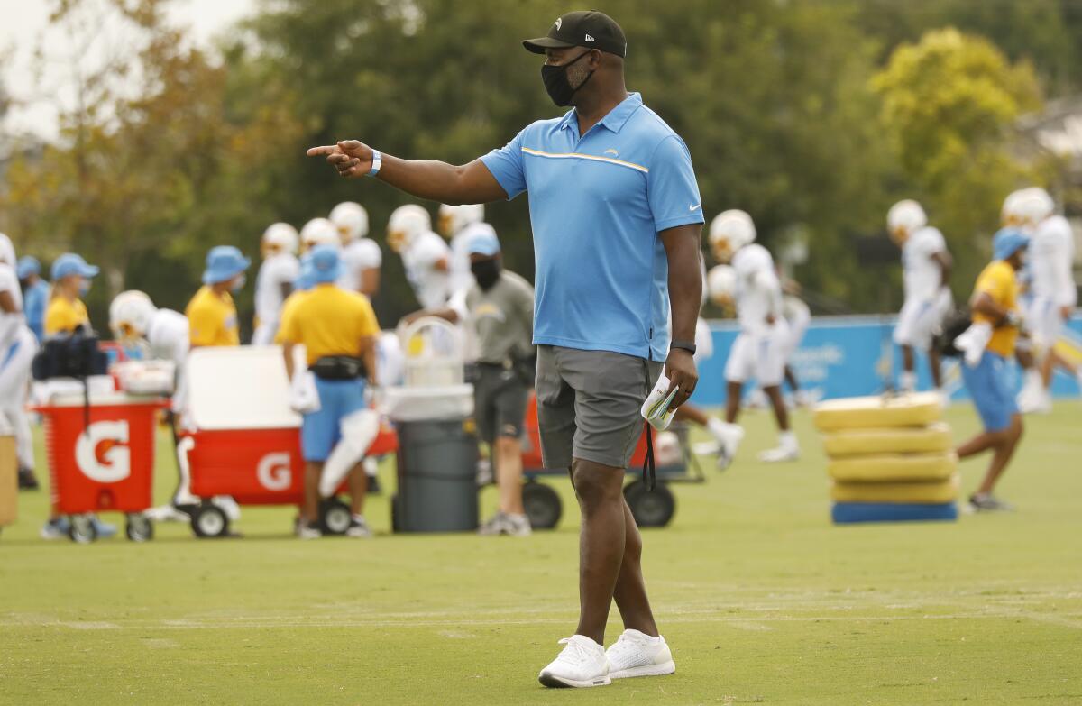 Chargers coach Anthony Lynn points to a player during practice in Costa Mesa on Monday.