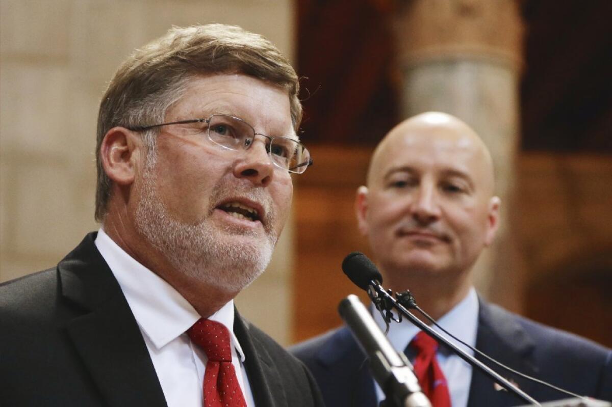 Nebraska Lt. Gov. Lavon Heidemann, left, speaks in Lincoln, Neb., at an event introducing him as the running mate of Republican gubernatorial candidate Pete Ricketts, right, in June. Three months later, Heidemann is off the ticket, though the official deadline to withdraw was Sept. 1.