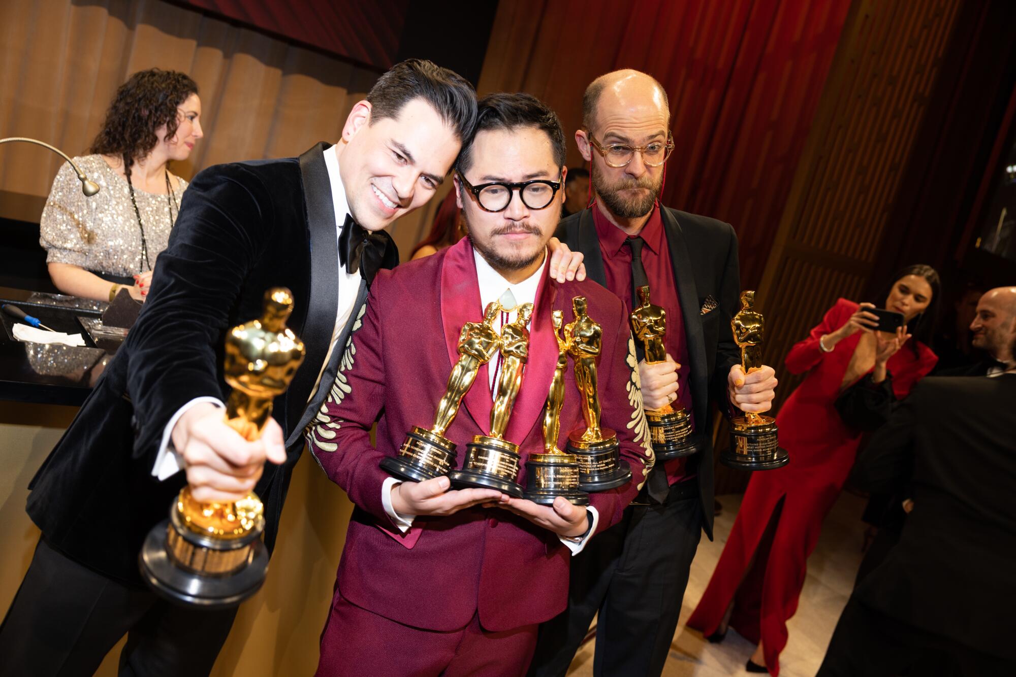 Jonathan Wang, Daniel Kwan and Daniel Scheinert balance all their Oscars.