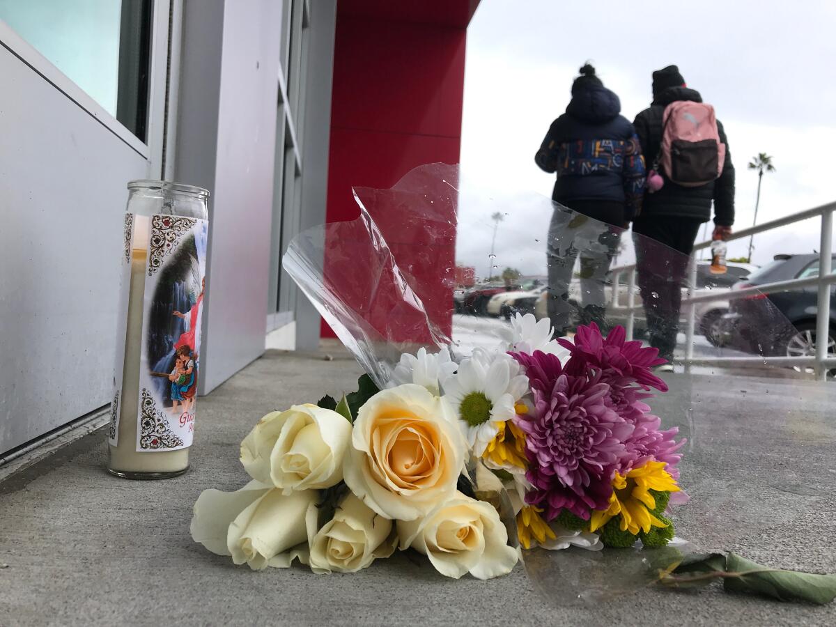 Flowers on the ground in tribute to slain 14-year-old