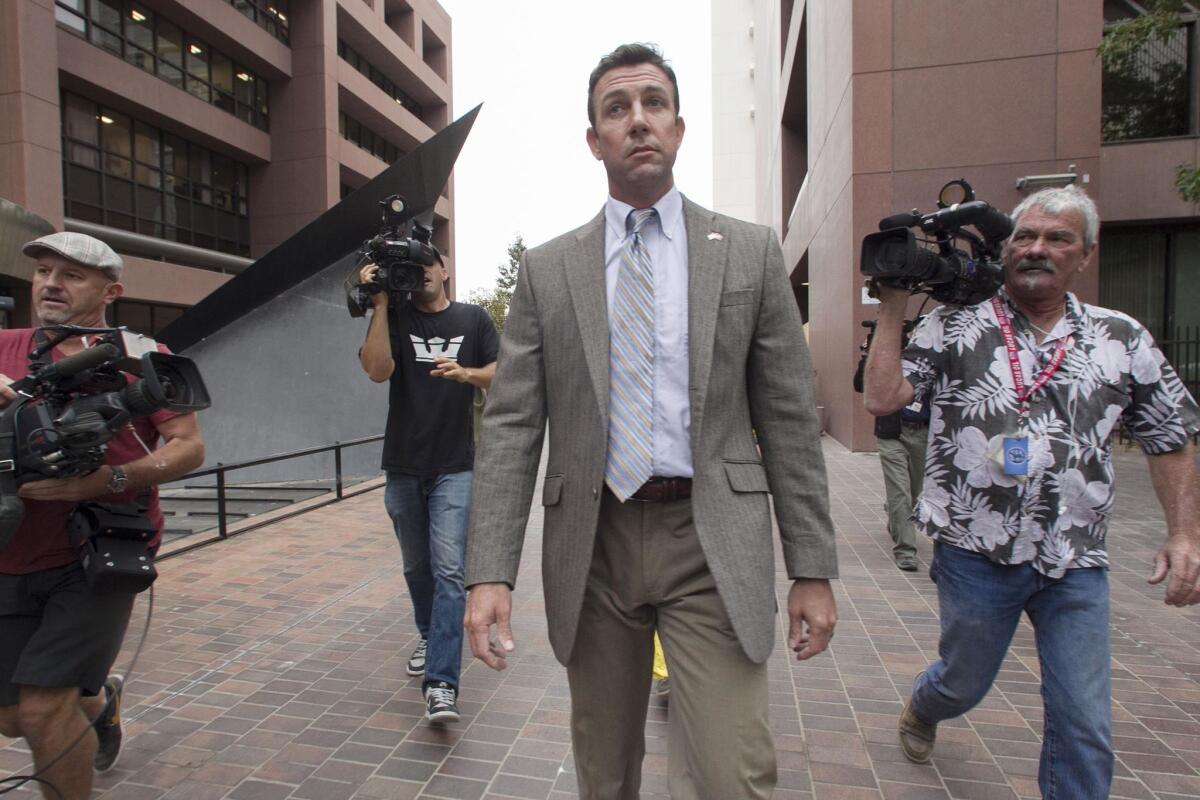 Then-Rep. Duncan Hunter leaves the courthouse complex in San Diego