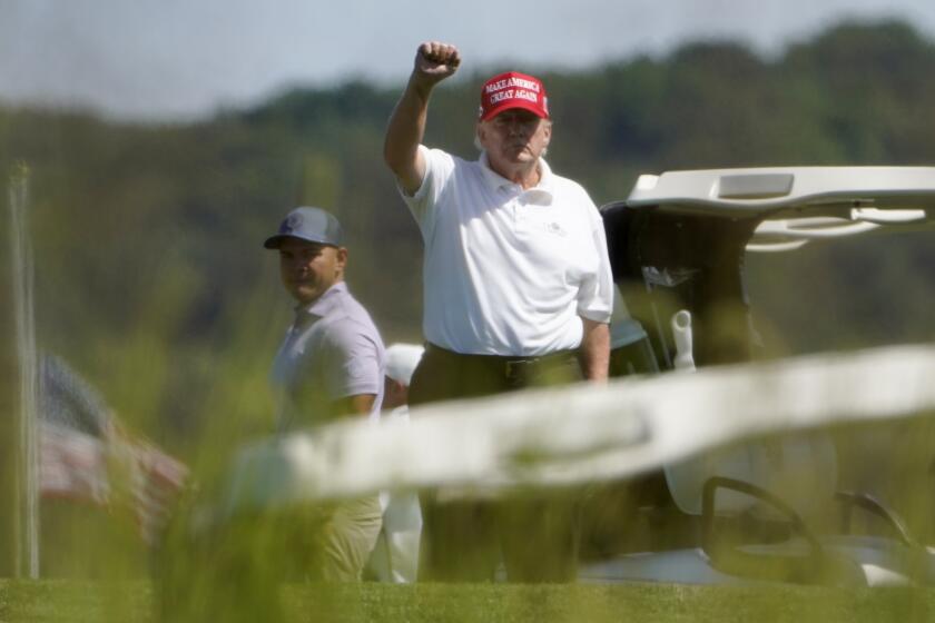 Former President Donald Trump gestures while playing golf at Trump National Golf Club in Sterling, Va., Tuesday, Sept. 13, 2022. (AP Photo/Manuel Balce Ceneta)