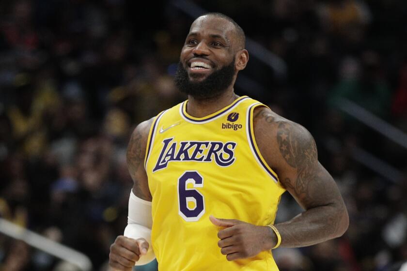 Los Angeles Lakers' LeBron James smiles during the second half of an NBA basketball game against the Washington Wizards