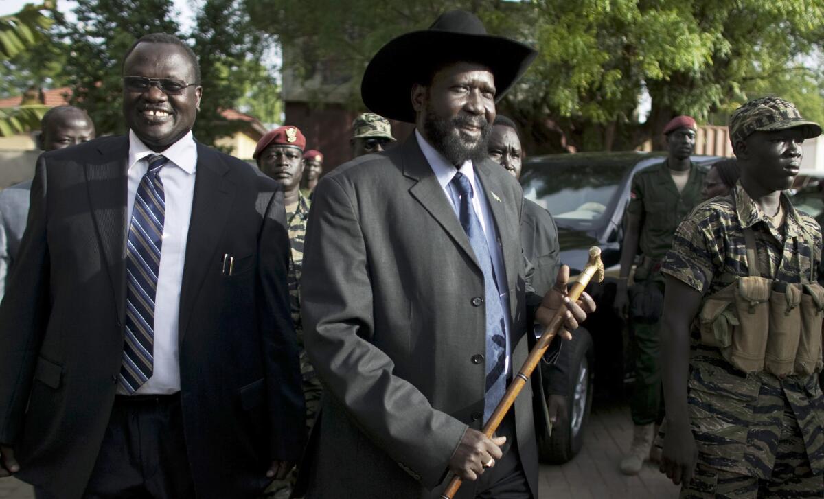 In this 2010 file photo, then-Vice President Riek Machar, left, and President Salva Kiir arrive for a news conference in Juba, South Sudan.