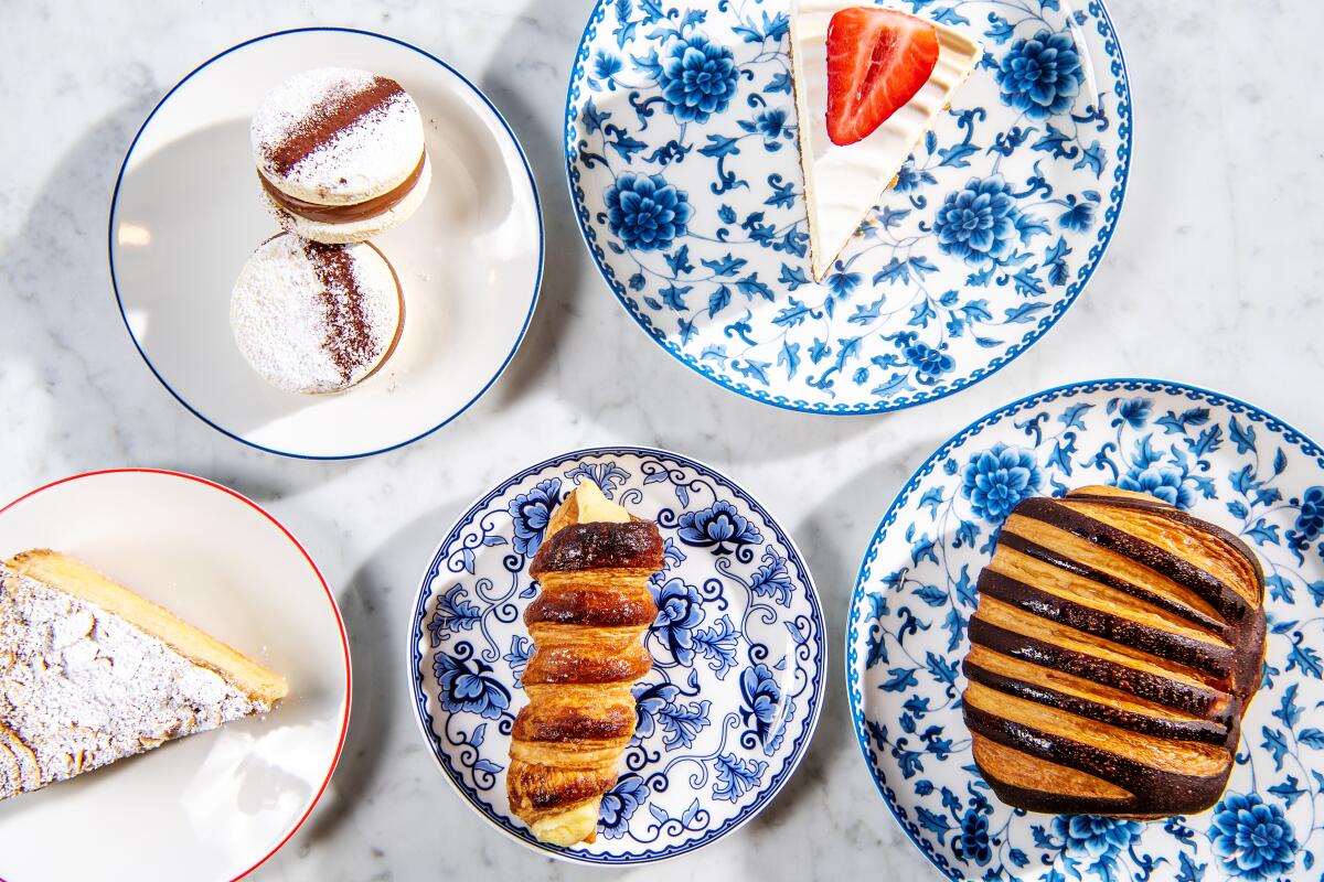 An array of pastries from Bianca Bakery, including mini alfajores, left, cheesecake, chocolate croissant, vanilla cannoncini and Basque cake.