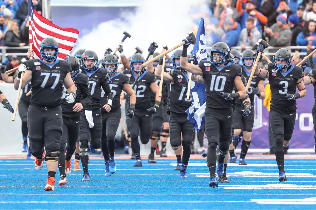 Boise State players enter the field prior to the start of first half action in the Mountain West championship against Hawaii on Dec. 7 in Boise, Idaho. Boise State won the game 31-10.