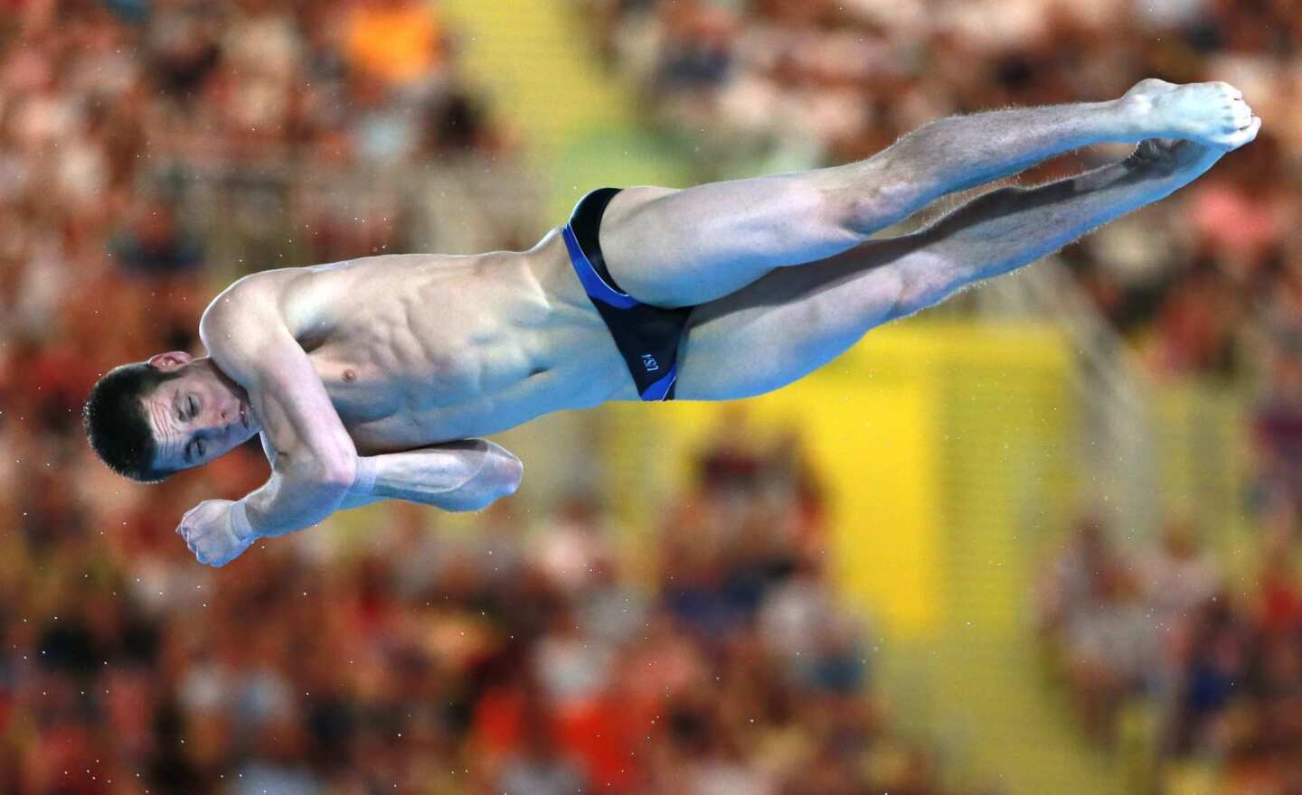 David Boudia of the United States spins through the air in the men's 10m platform diving competition. He won the gold medal.