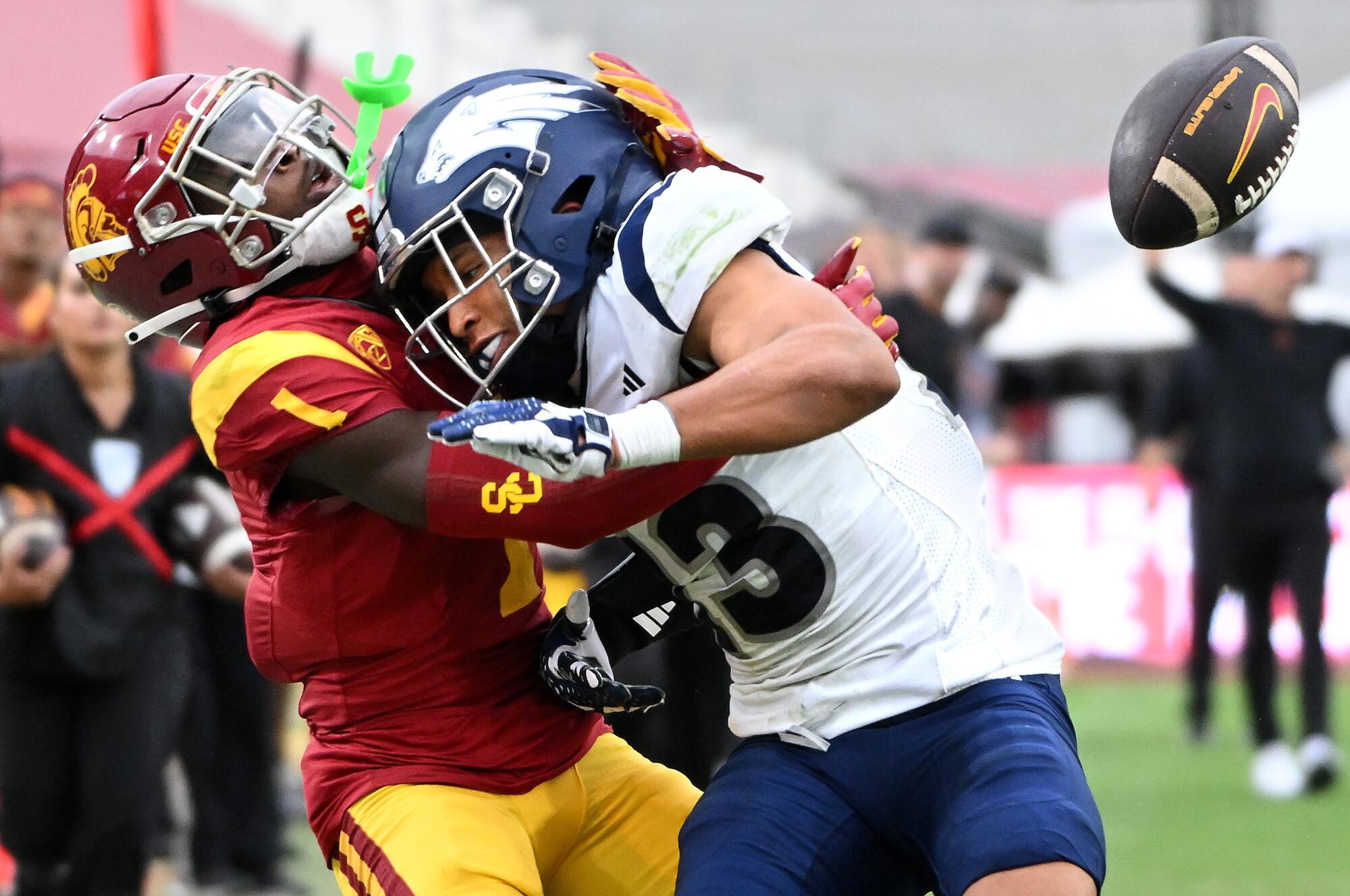 A USC receiver and a Nevada defender tangle as the ball falls incomplete