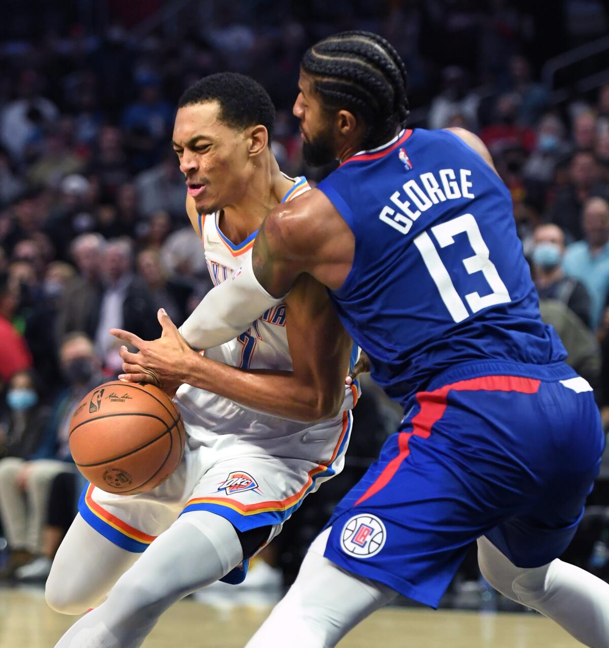 Clippers' Paul George steals the ball away from Oklahoma City Thunder's Amir Coffey.