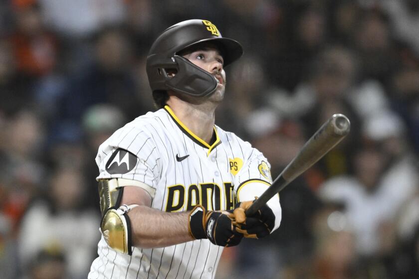 San Diego Padres' Graham Pauley watches the flight of his three-run home run during the ninth inning of a baseball game against the San Francisco Giants, Saturday, March 30, 2024, in San Diego. (AP Photo/Denis Poroy)