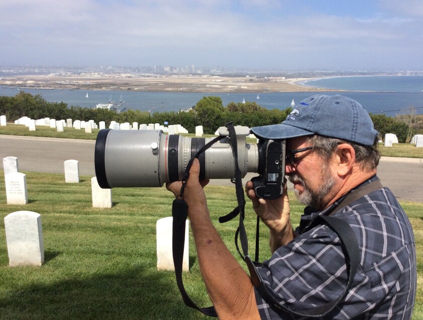 Union-Tribune photojournalist John Gibbins takes photos at Fort Rosecrans National Cemetery.