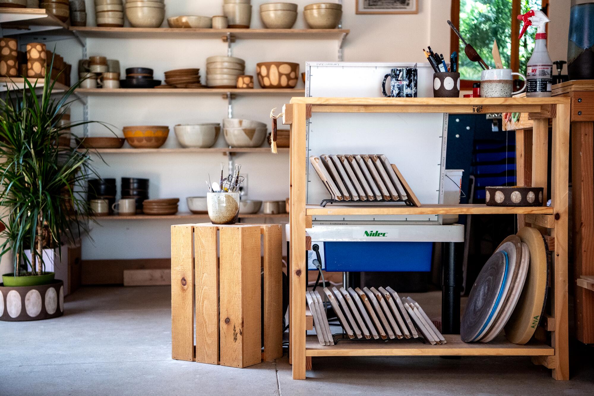 Shelving with handcrafted pots and bowls.