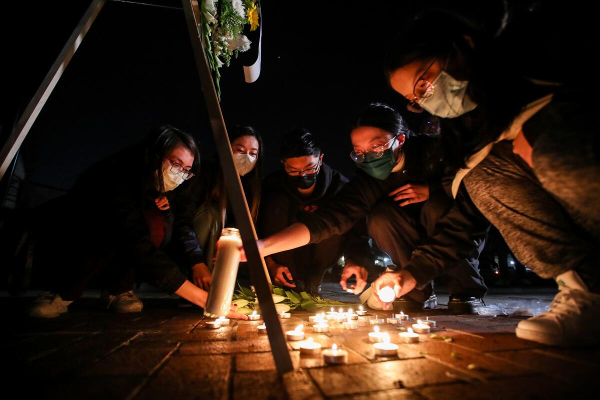 Mourners take part in a vigil for the victims of a mass shooting at the Star Dance Studio.