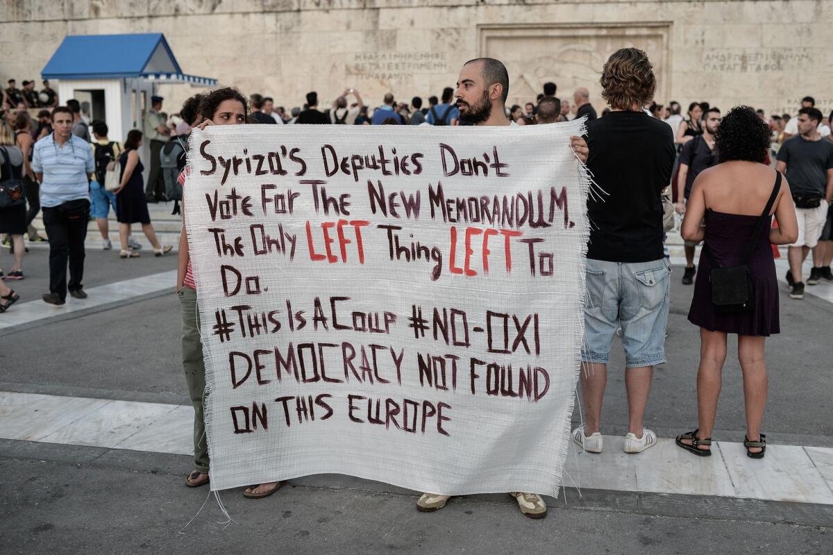 Leftists protesters hold a banner in front of the Greek Parliament in Athens at a July 13 anti-European Union demonstration calling for a no vote on any agreement with creditors. Eurozone leaders struck a deal later that day on a bailout to prevent Greece from crashing out of the euro, forcing Athens to push through draconian reforms.