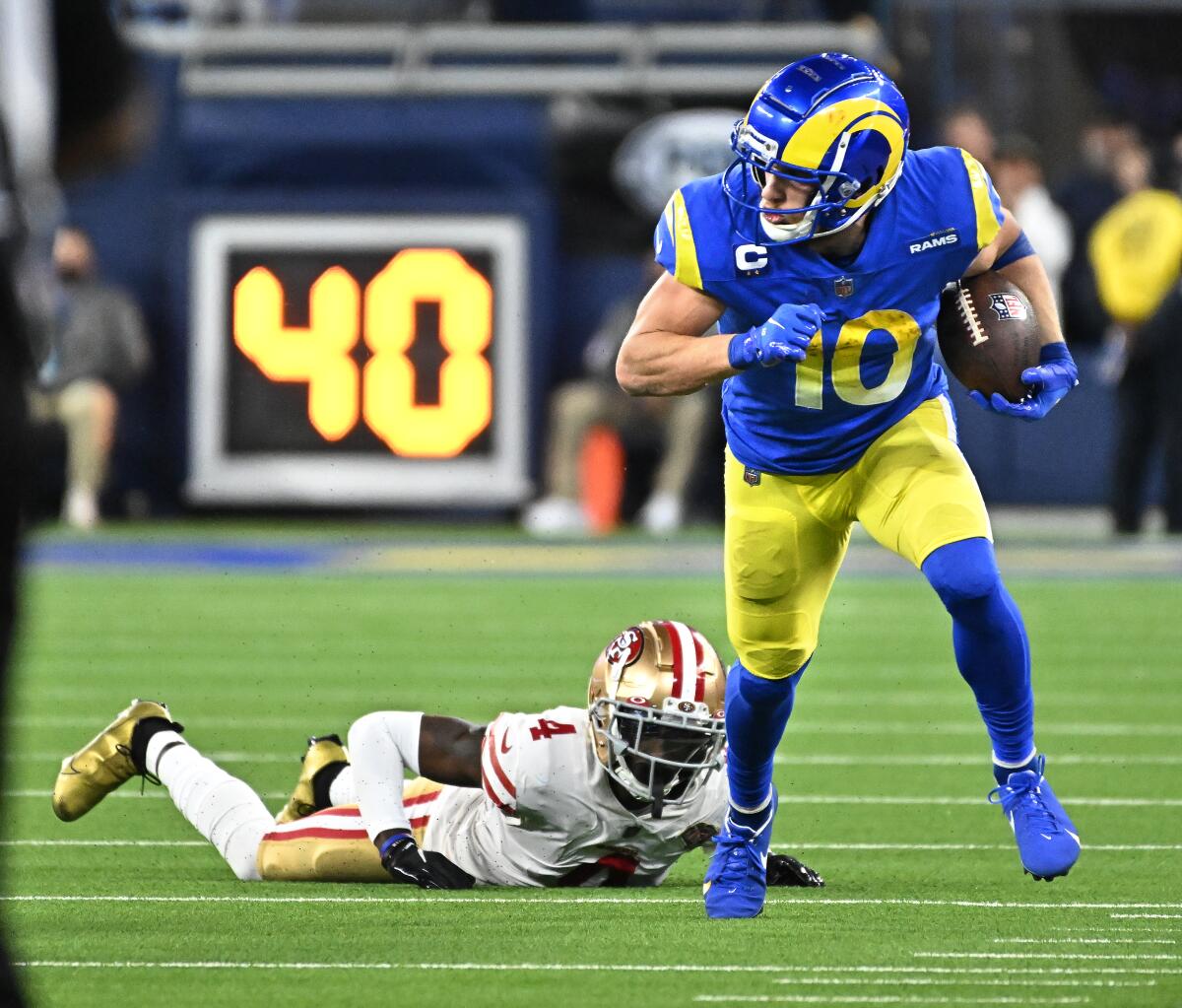 Rams receiver Cooper Kupp breaks the tackle of 49ers cornerback Emmanuel Moseley.