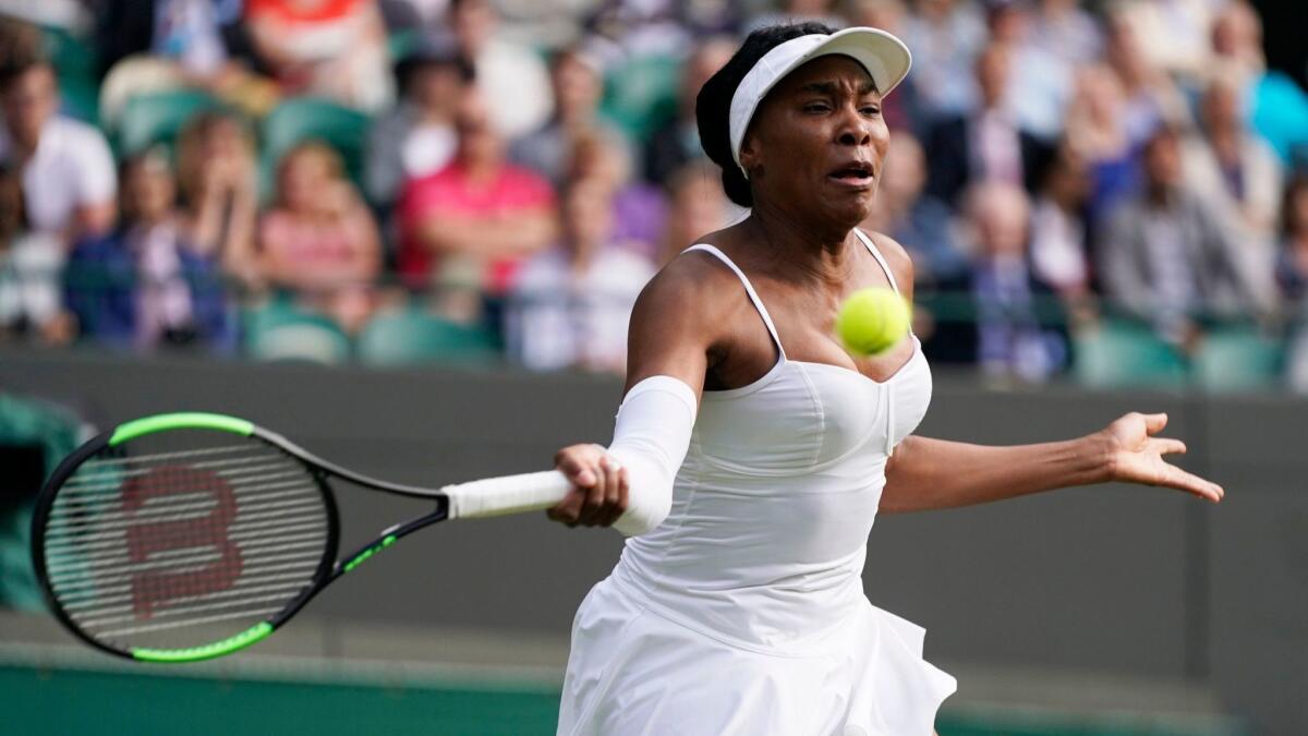 Venus Williams hits a return during her match against Cori Gauff at Wimbledon on Monday.