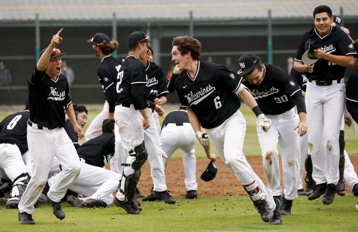 Harvard Westlake's Michael Snyder (6) celebrates with his team after driving in the winning run to beat Orange Lutheran 4-3.