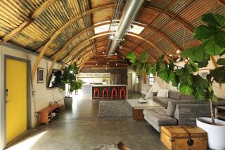 OCEANSIDE, CA - JULY 14: Iain Harris and his wife Annie purchased an old quonset hut built around 1942 and converted into a home in Oceanside. In addition they built a two-unit ADU casita to offset some of the costs. Here, the living area and kitchen are shown on Thursday, July 14, 2022. (K.C. Alfred / The San Diego Union-Tribune)