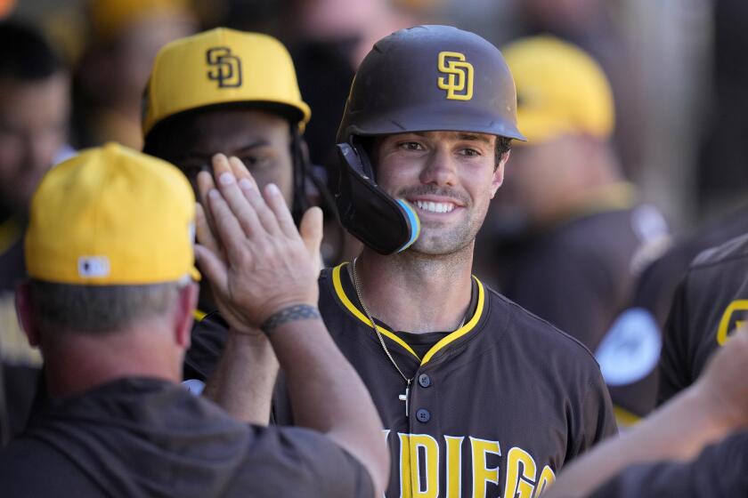 San Diego Padres' Graham Pauley smiles as he celebrates his run scored against the Arizona Diamondbacks during the fourth inning of a spring training baseball game Tuesday, March 5, 2024, in Scottsdale, Ariz. (AP Photo/Ross D. Franklin)