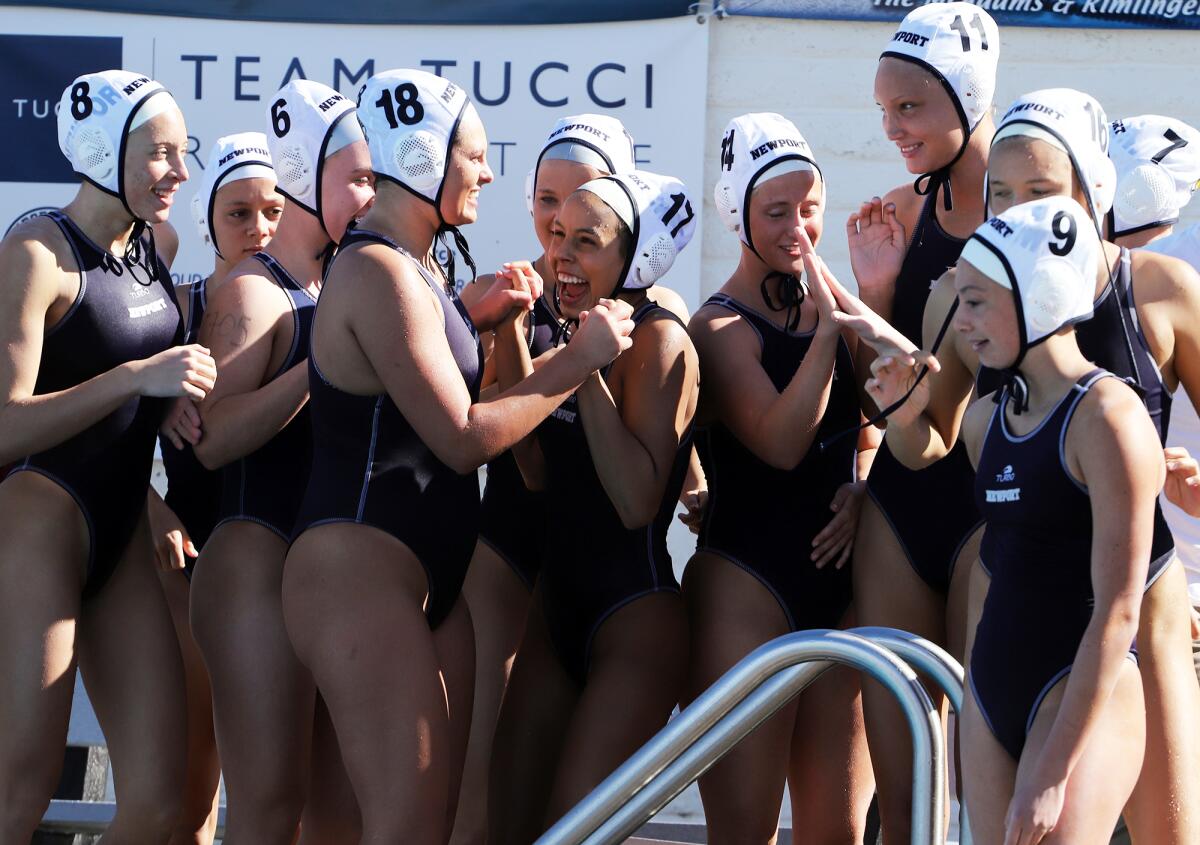 The Newport Harbor's girls' water polo team celebrates after winning in the semifinals of the Newport Invite on Saturday.