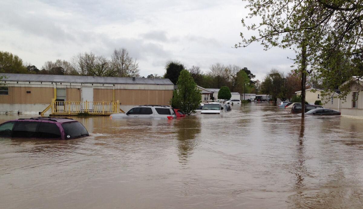 Flood waters cover a street in a mobile home park in Pelham, Ala., on Monday. Police and firefighters had to rescue people who were trapped by muddy, fast-moving water after storms dumped torrential rains in central Alabama.